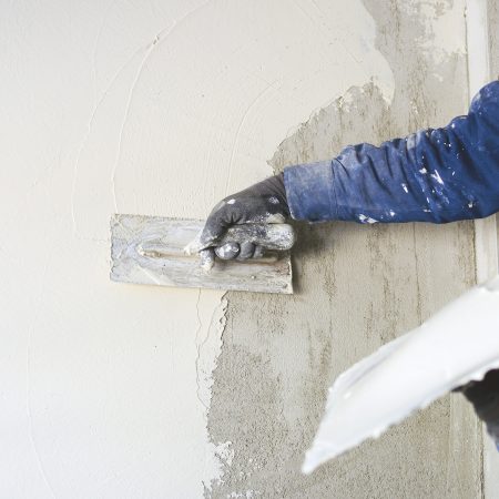 worker plastering tool plaster marble on interior plaster rough.  Selective focus